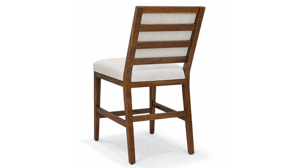 Wooden bar stool with a white cushion on a white background