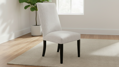 White upholstered chair with black legs on a white background