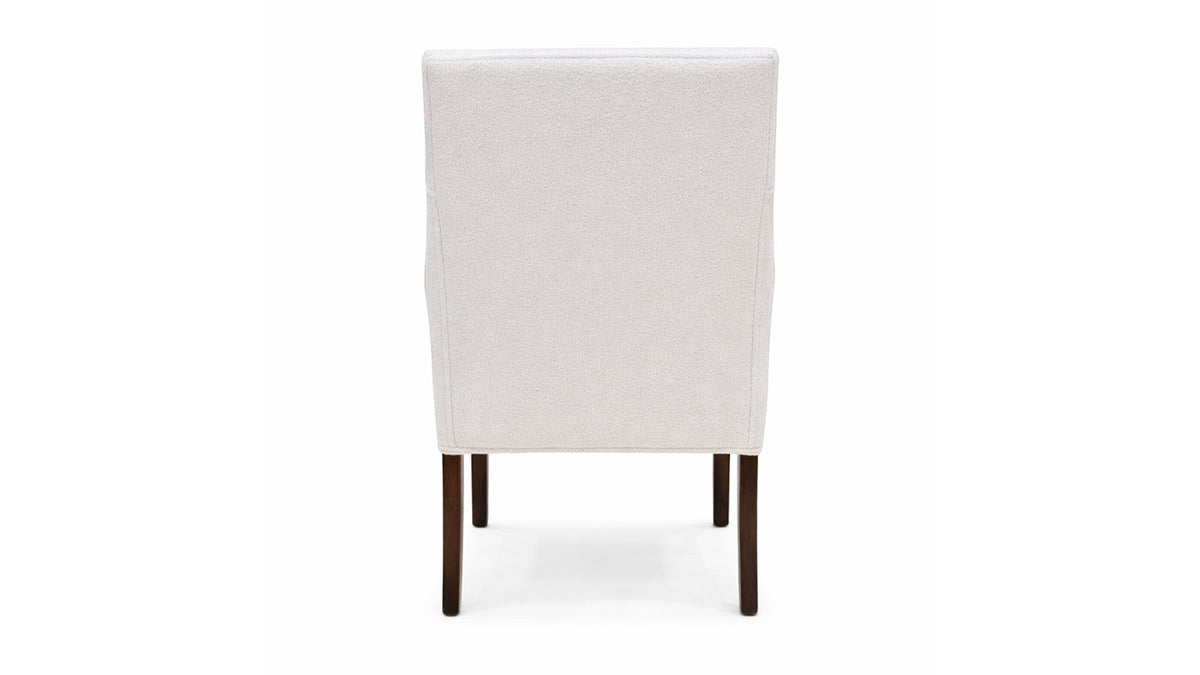 White upholstered chair with dark wooden legs on a white background