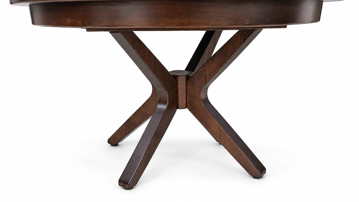 A close-up of a dark brown wooden dining table base with a round tabletop and four angled legs, shown against a plain white background.