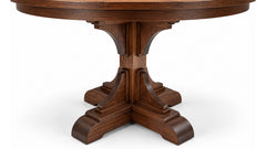 A dark brown wooden pedestal dining table shown from a low angle against a white background.