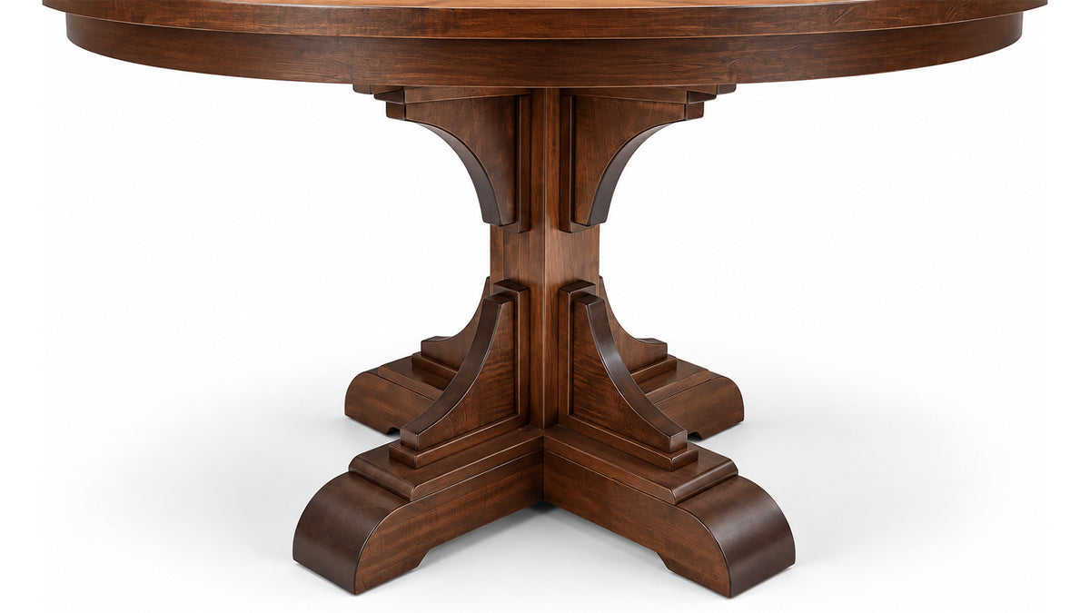 A dark brown wooden pedestal dining table shown from a low angle against a white background.