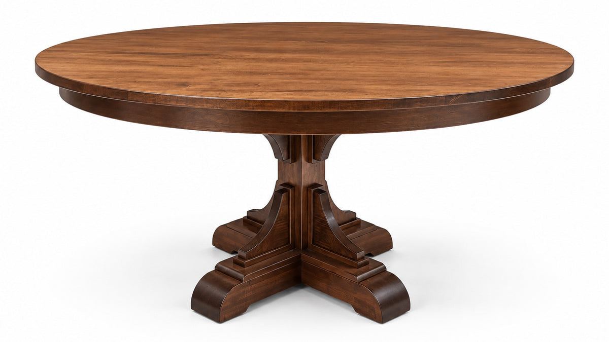 A round wooden dining table with a dark brown finish and a carved pedestal base, shown on a plain white background.