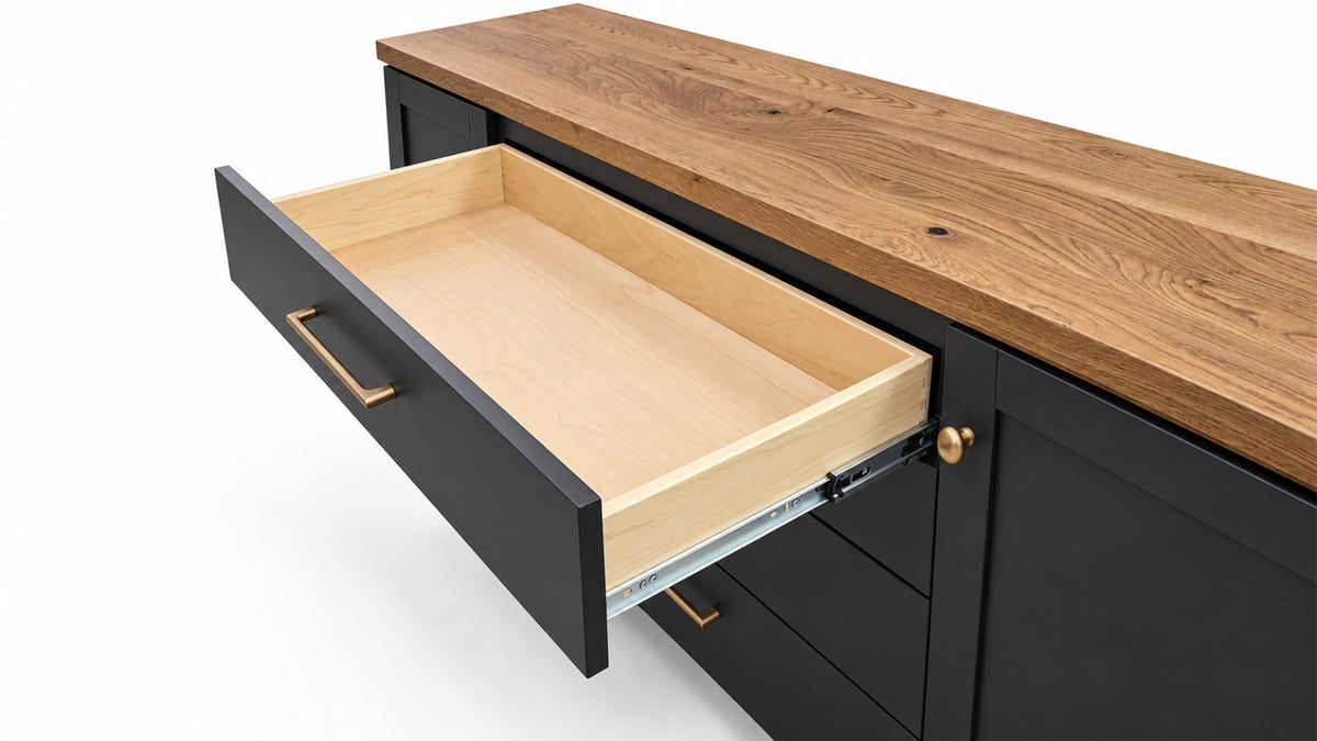 A black kitchen cabinet drawer with a light natural wood interior, shown partially open on a white background.