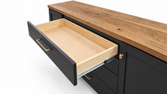 A black kitchen cabinet drawer with a light natural wood interior, shown partially open on a white background.