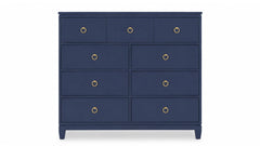 Navy blue dresser with gold knobs on a white background