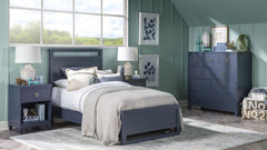 Modern bedroom with blue furniture, including a bed, nightstands, and dresser.