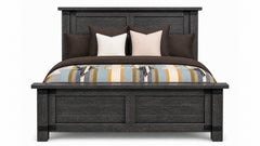 Wooden bed with striped bedding and pillows on a white background
