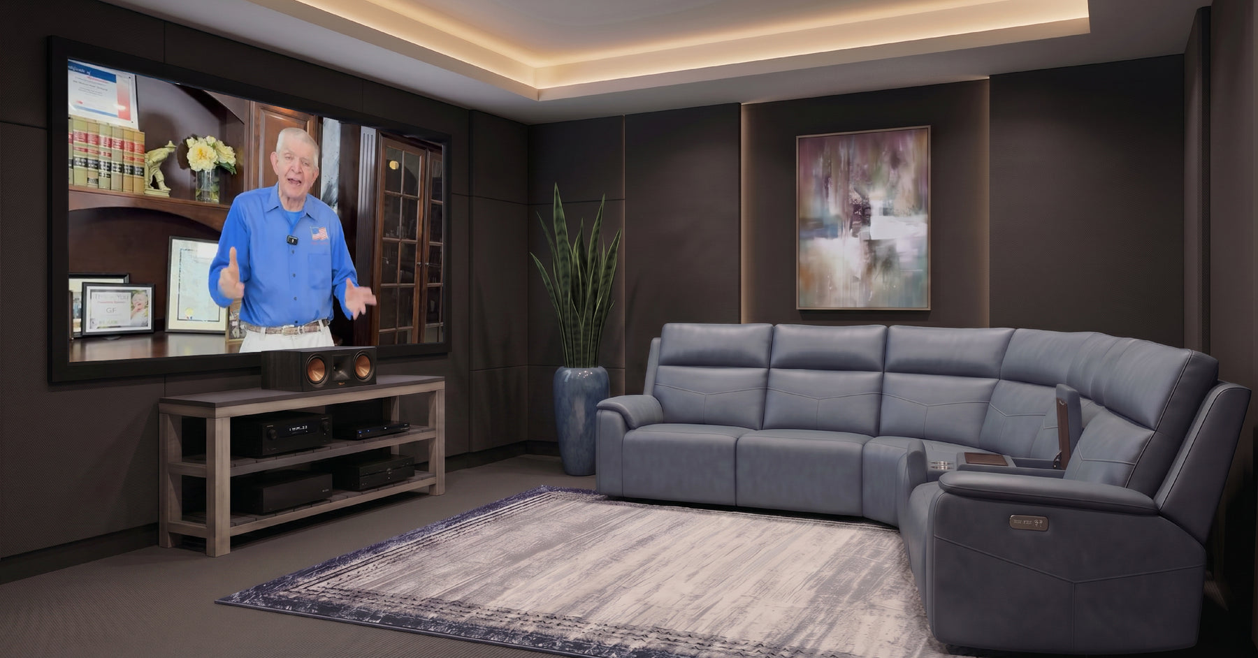 Modern living room with a large flat-screen TV, gray sectional sofa, and decorative elements.