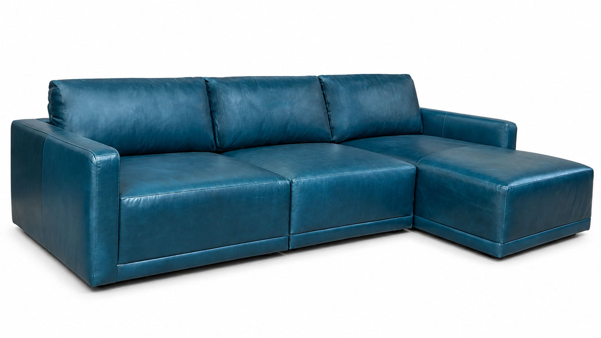 A modern sectional sofa with a right-facing chaise lounge, upholstered in a textured teal blue leather, shown against a plain white background.