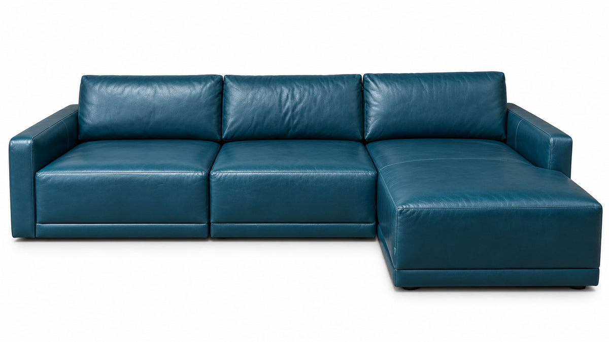 A modern sectional sofa with a right-facing chaise lounge, upholstered in a deep teal blue leather, shown against a plain white background.