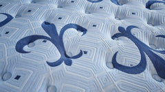 Close-up of a textured mattress surface with a brand logo.