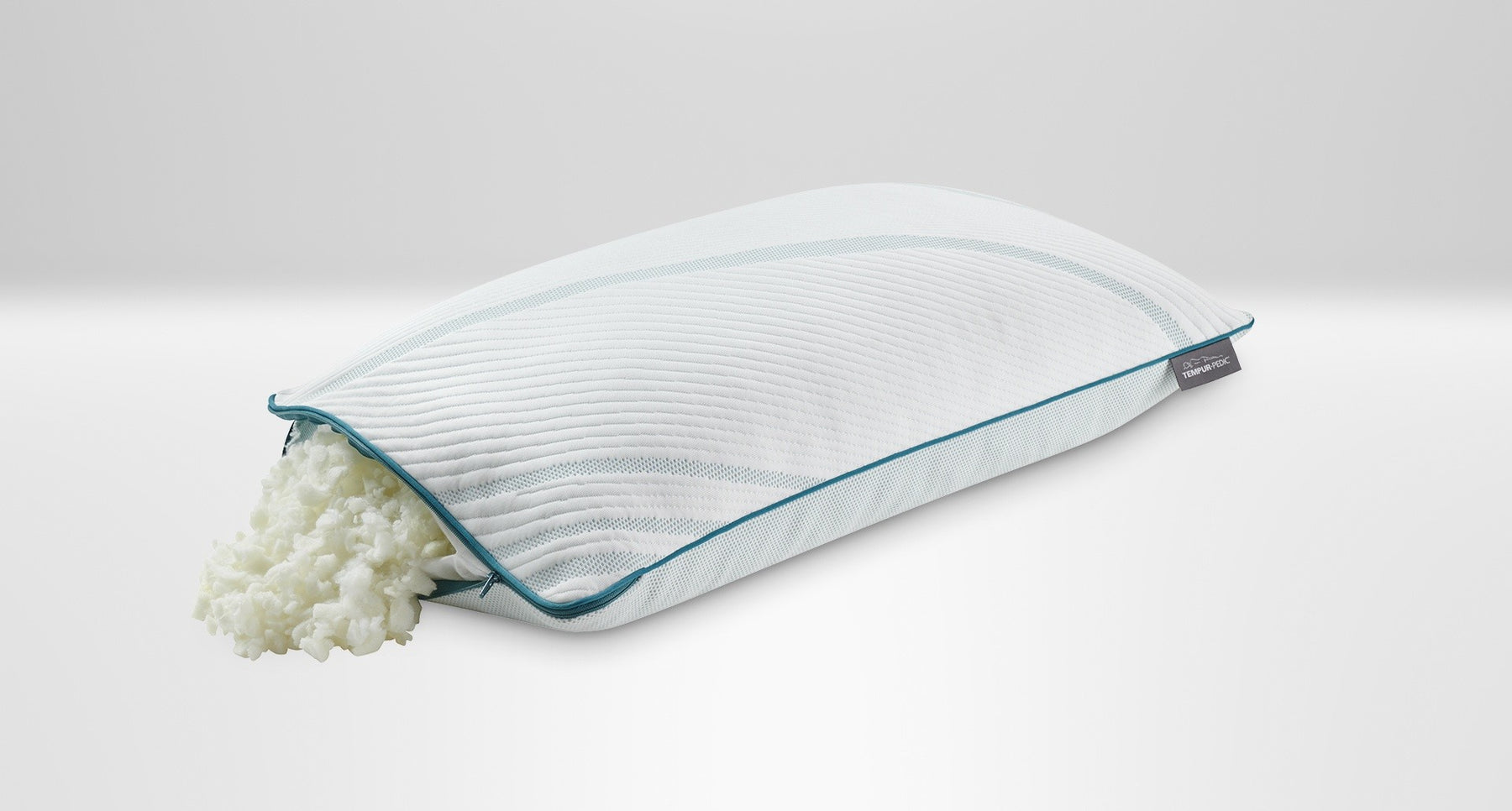 A king-sized Tempur-Pedic memory foam pillow with its cover removed, showing the foam layers, on a white background.