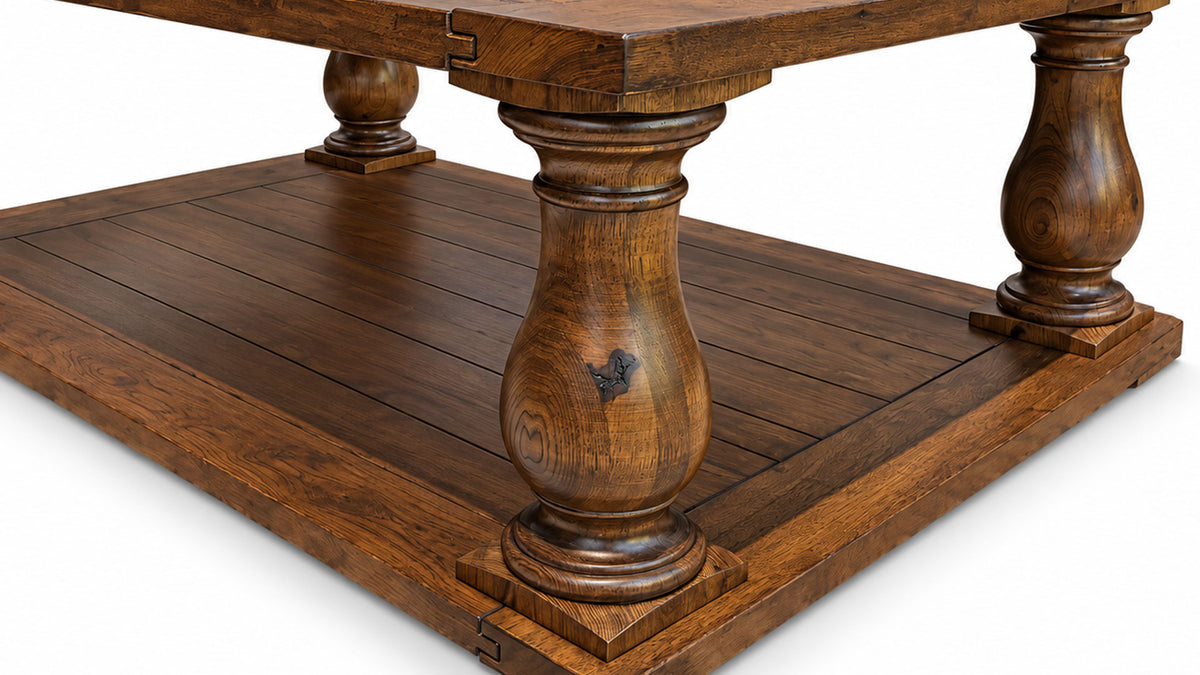 Close-up of a rustic wooden table with turned pedestal legs and a lower shelf, shown on a white background.