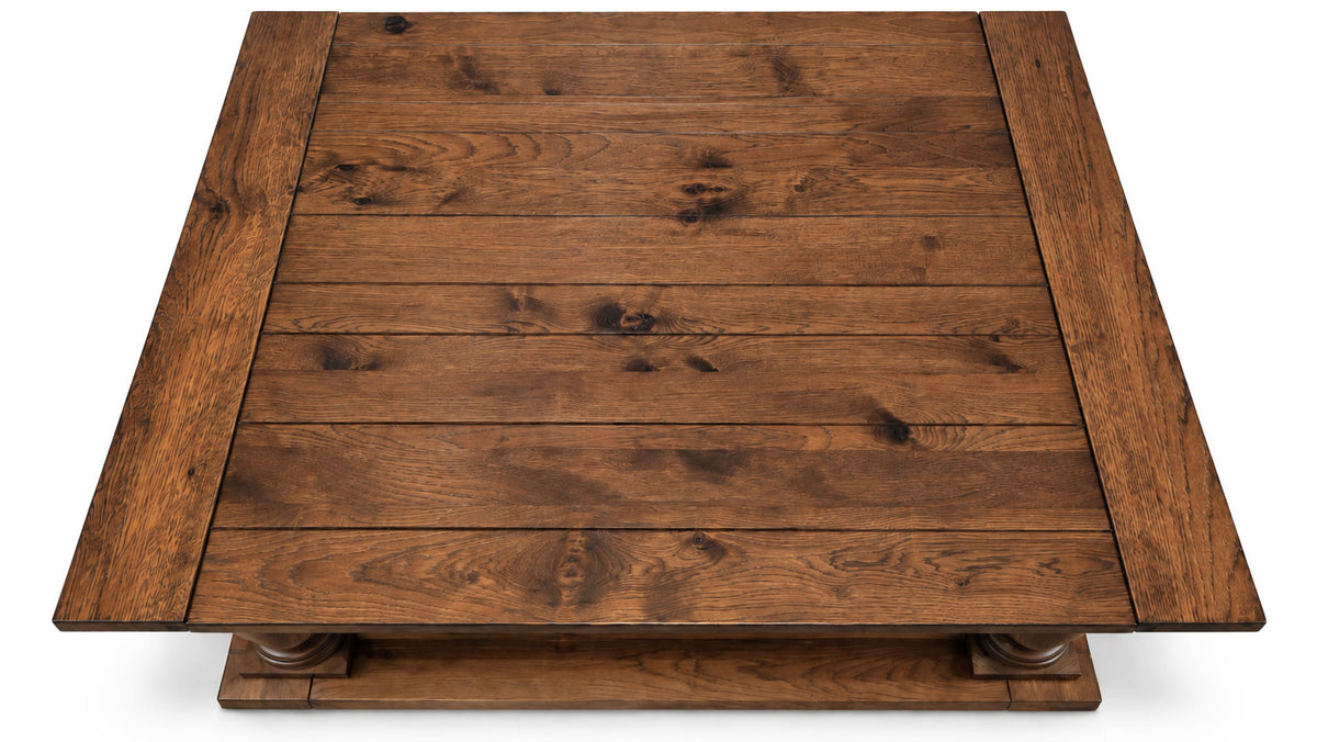A square wooden coffee table with a rustic dark brown finish, featuring a slatted top and a raised base with decorative turned legs, shown from a top-down perspective on a white background.