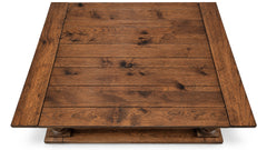 A square wooden coffee table with a rustic dark brown finish, featuring a slatted top and a raised base with decorative turned legs, shown from a top-down perspective on a white background.