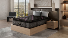 A queen size Beautyrest Black Series 2 Plush Pillowtop Mattress in a bedroom setting, featuring a plush top with a patterned design and a supportive base structure.