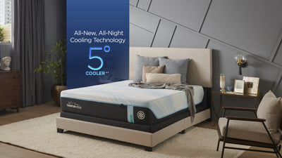 A queen-sized Tempur-Pedic hybrid mattress displayed in a bedroom setting, featuring cooling technology and a medium hybrid feel.