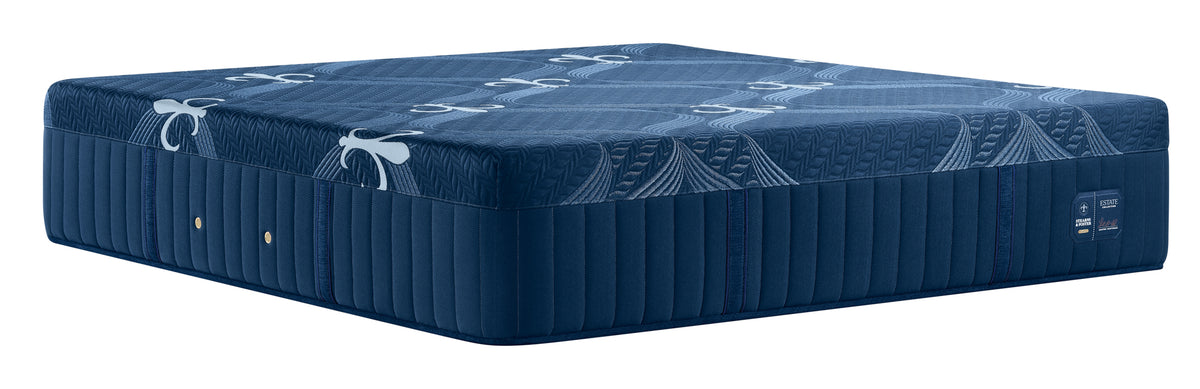 A dark blue mattress with a quilted side panel and a patterned top surface, shown on a plain white background.