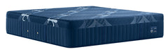 A dark blue mattress with a quilted side panel and a patterned top surface, shown on a plain white background.