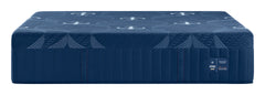 A dark blue mattress with a quilted top surface featuring a repeating anchor pattern and a ribbed side panel, shown on a plain white background. A small label on the side reads 'KESAGO' and 'FIRM'.