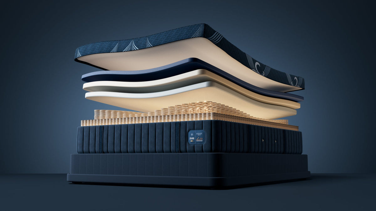 A luxury mattress stack displayed in a clean, studio-like setting with no people or real-world environment, showcasing multiple layers of the mattress construction.