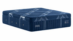 A dark blue mattress with a matching mattress base, featuring quilted side panels and the brand name 'Stearns & Foster' printed on the side, set against a plain white background.
