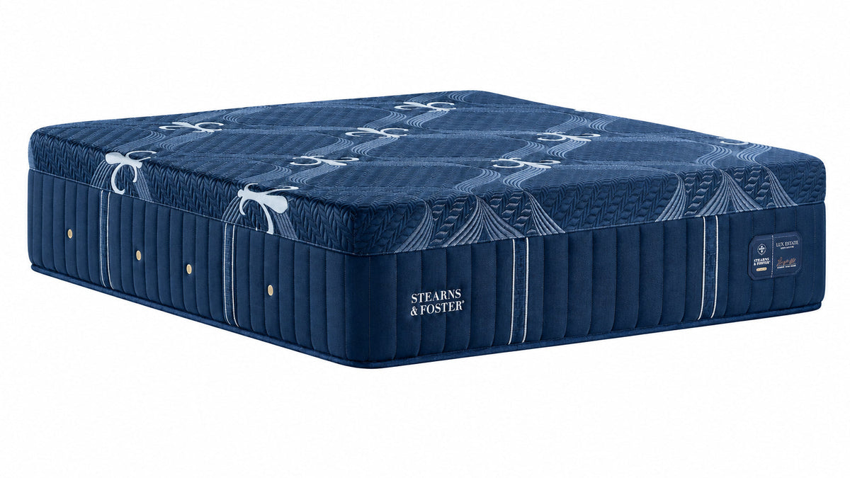 A dark blue mattress with a matching mattress base, featuring quilted side panels and the brand name 'Stearns & Foster' printed on the side, set against a plain white background.