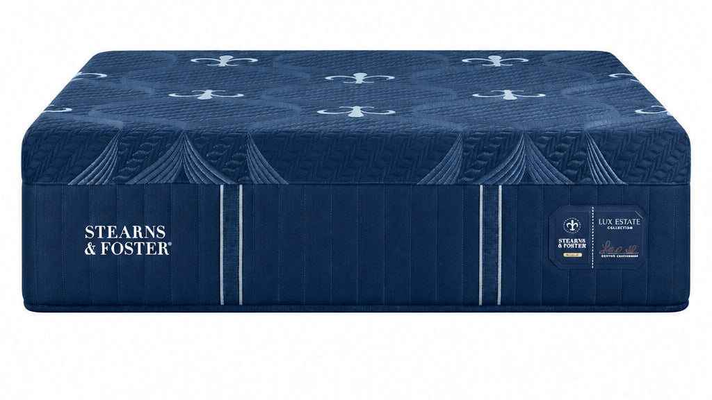 A dark blue mattress shown from a three-quarter angle, resting on a matching dark blue mattress base. The brand name 'STEARNS & FOSTER' is clearly visible on the side of the mattress.