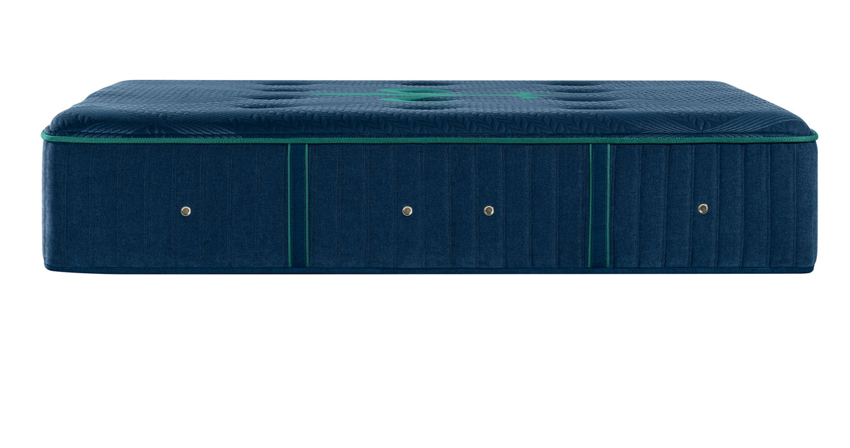 A dark blue upholstered mattress shown from the side against a plain white background.