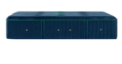 A dark blue upholstered mattress shown from the side against a plain white background.