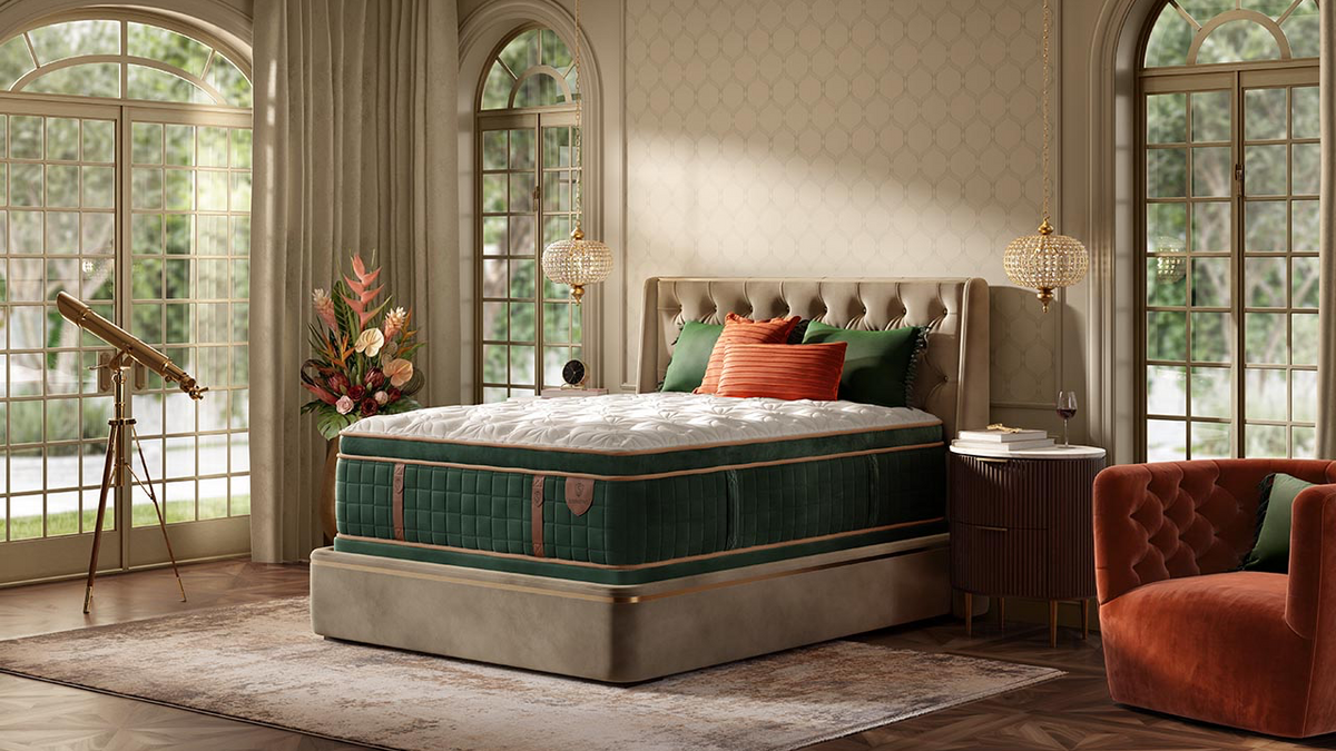 Luxury bedroom with a large bed, armchair, and decorative elements.