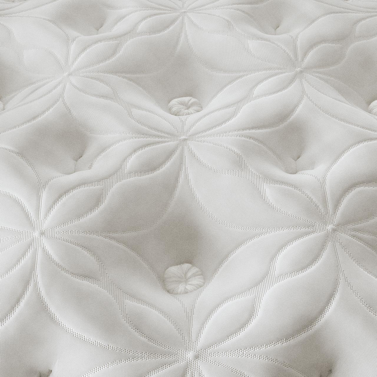 Close-up of a white quilted mattress surface