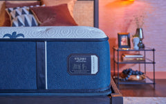 Blue mattress with 'Studio Collection' label in a bedroom setting