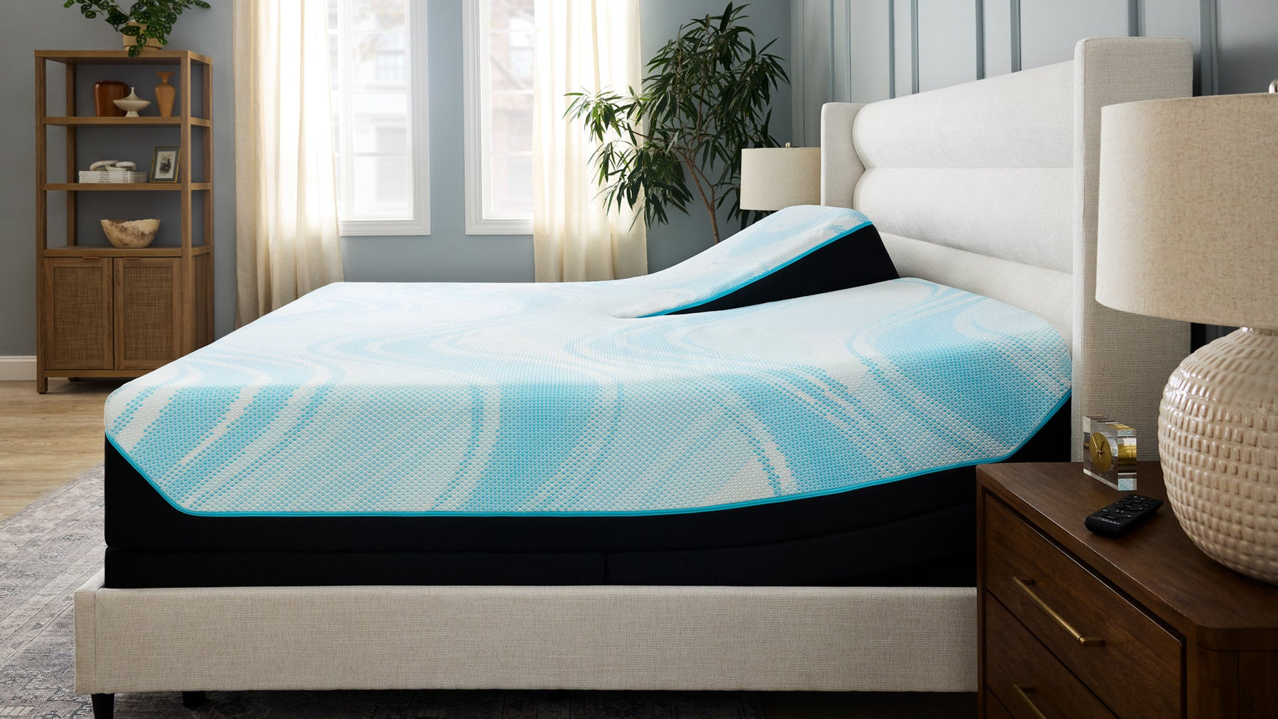 Mattress with blue and white cover on a bed in a bedroom setting
