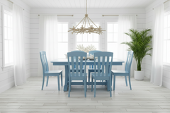 Dining room with a blue table and chairs in a bright, white room.