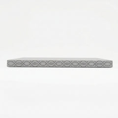 A side view of a gray mattress on a solid black background.