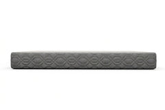 A rectangular gray textured panel with a repeating geometric pattern, shown horizontally against a dark gradient background.