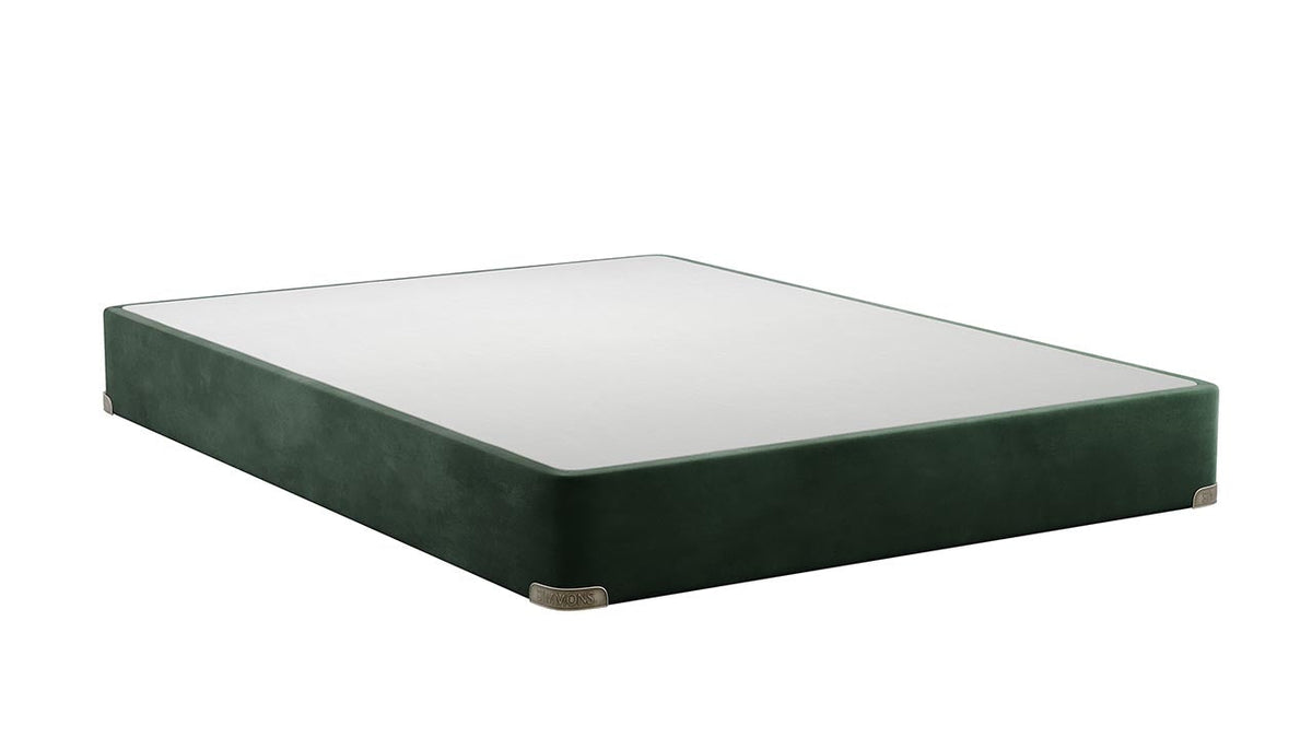 A dark green upholstered bed frame or platform bed with a white mattress, shown at an angle on a plain white background.