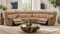 Beige sectional sofa in a living room with a coffee table and decorative elements.