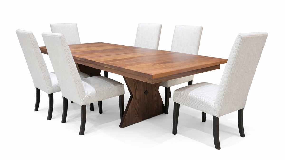 Wooden dining table with six white chairs on a white background