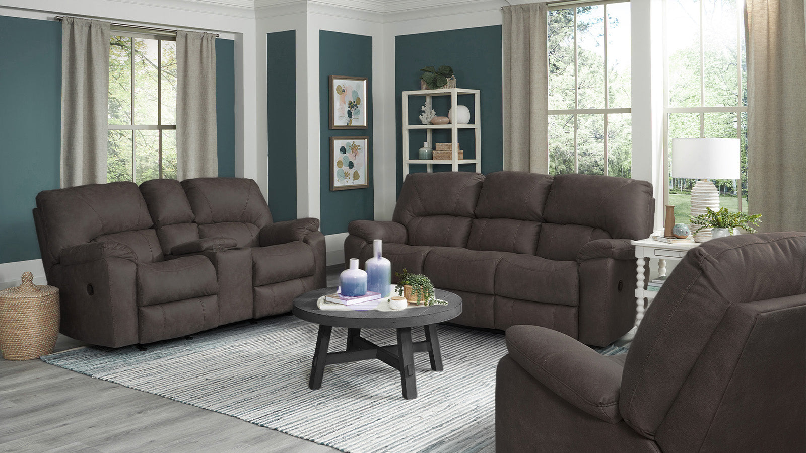 Living room with brown reclining sofas and a small round table.