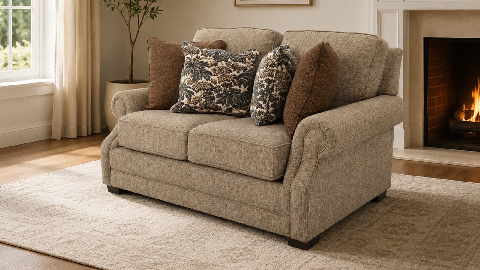 Beige sofa with patterned and brown cushions in a living room setting with a fireplace.
