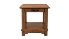 A rustic wooden end table with a single drawer featuring a black metal pull handle, a lower shelf, and a warm medium-brown finish, shown against a plain white background.