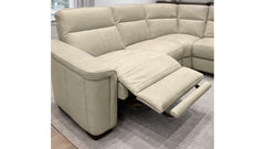 Beige sectional sofa with recliner feature in a room setting