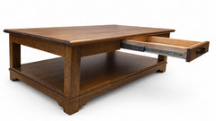 A dark brown wooden coffee table with a lower shelf and an open drawer pulled out to the right, shown on a white background.