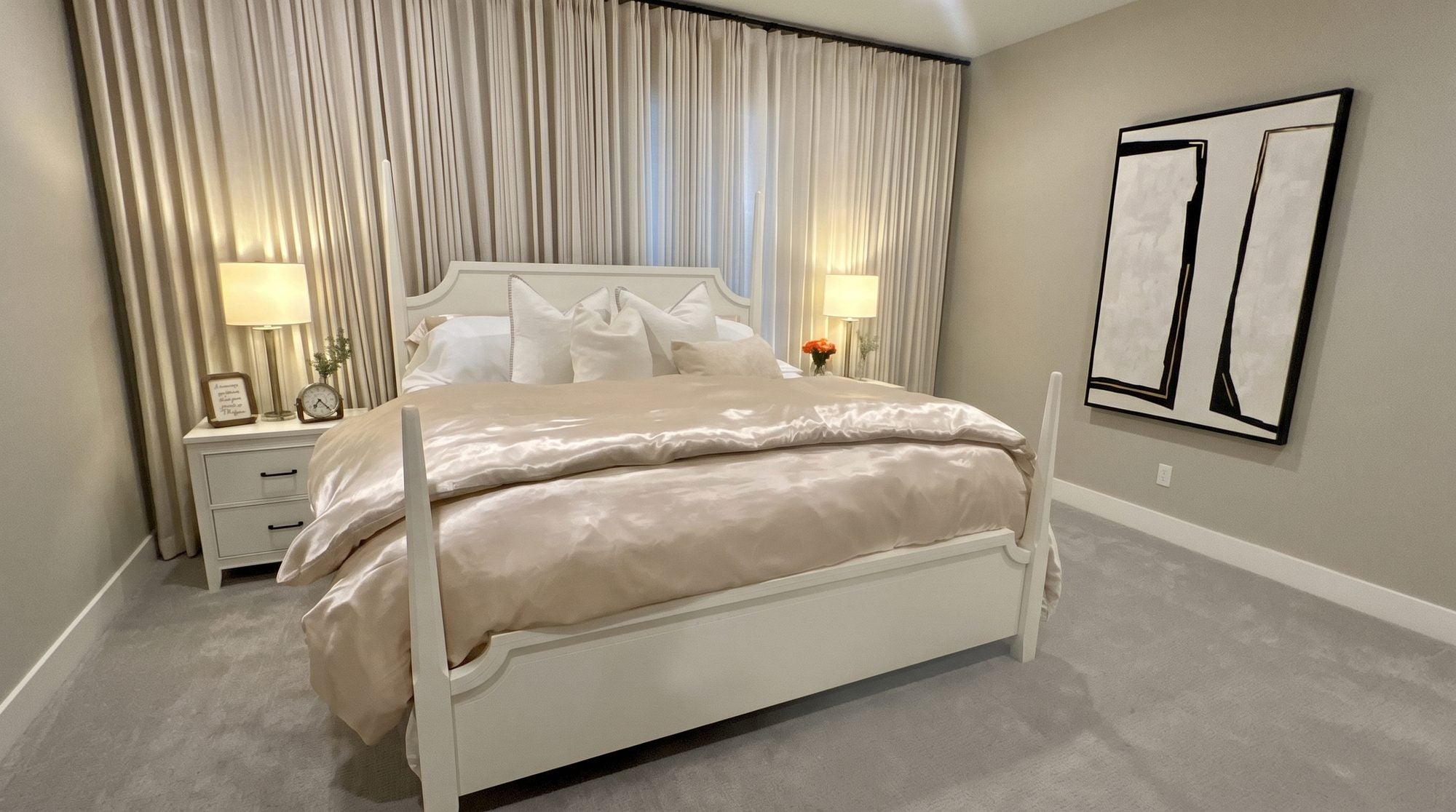 Primary bedroom after transformation with Tempur-Pedic mattress, boucle wingback bed, and layered linen bedding