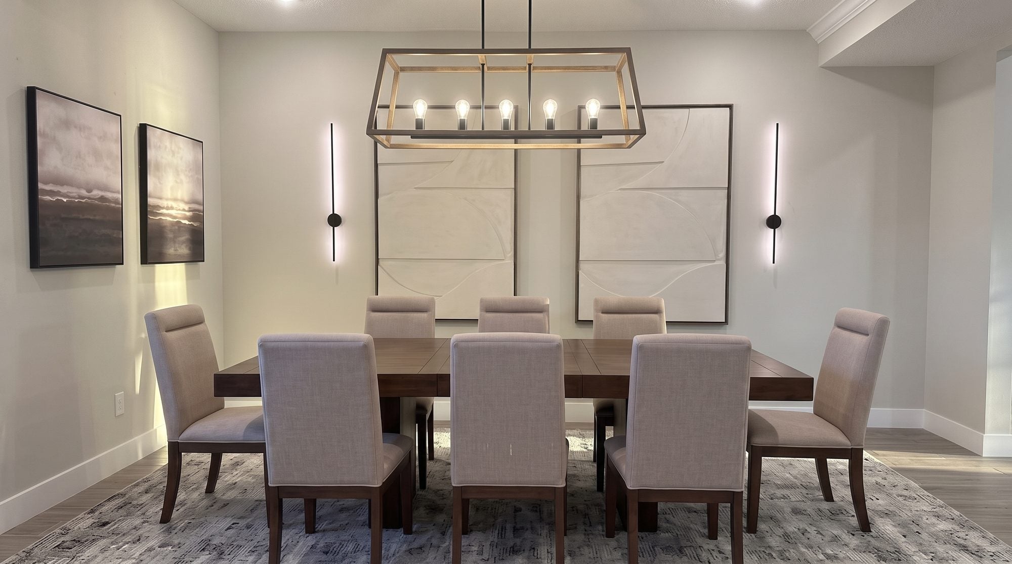 Dining room after transformation with solid walnut trestle table, cognac leather chairs, and linear chandelier