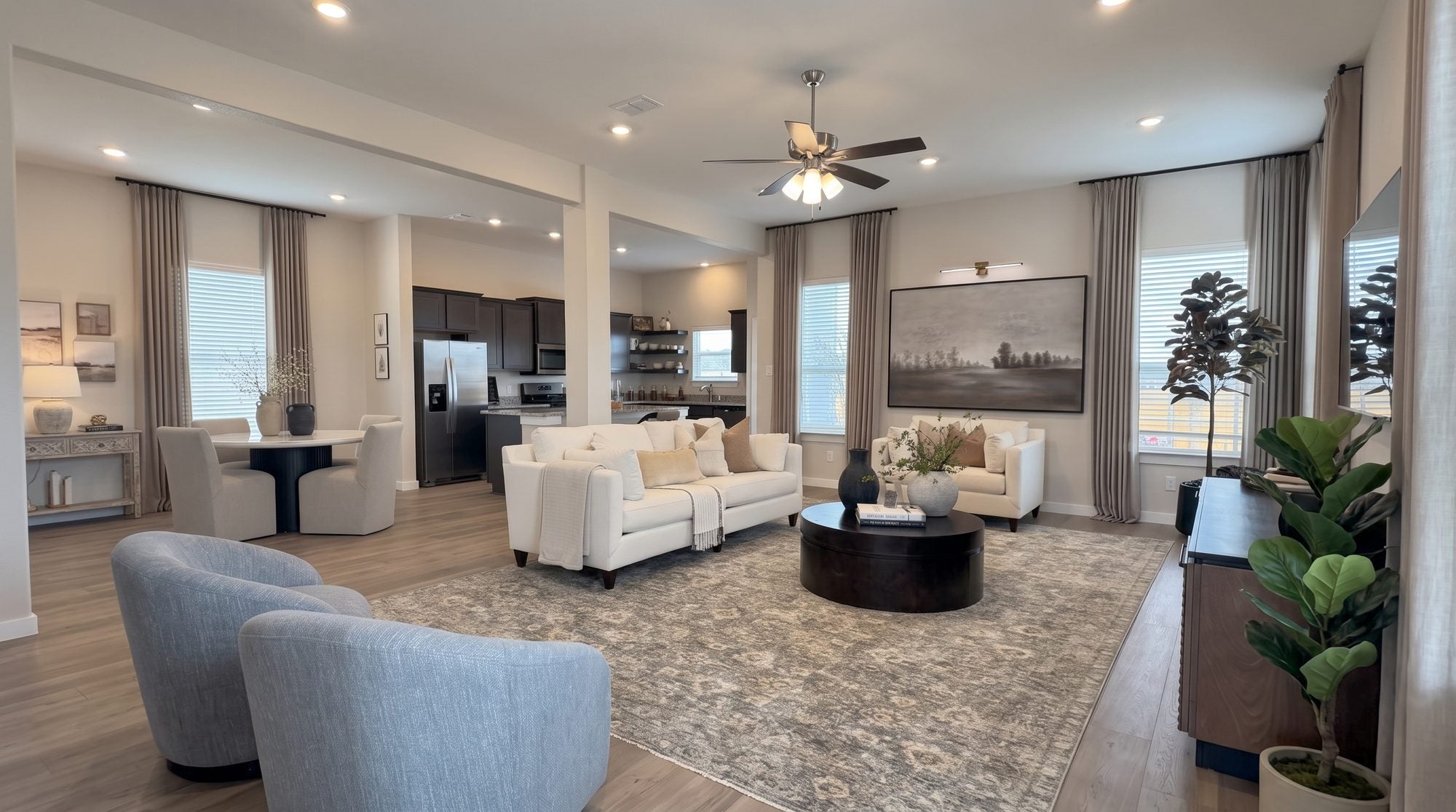 Living room after Gallery Furniture transformation with leather sectional, walnut coffee table, and warm lighting